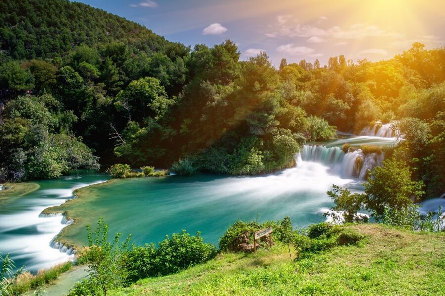 From Omiš: Krka Waterfalls and Trogir Small Group Tour - Skradinski Buk waterfalls and the travertine barrier walk
