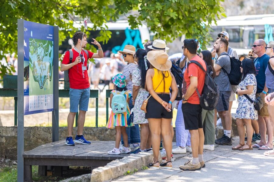 From Split: Krka Waterfalls day tour & wine tasting - Boat ride views after the park walkways