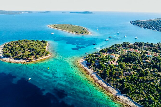 Private Half-Day Boat Tour from Split: Blue Lagoon & 2 Islands - Blue Lagoon and Krknjasi Bay: clear water, snorkeling gear, and small moments