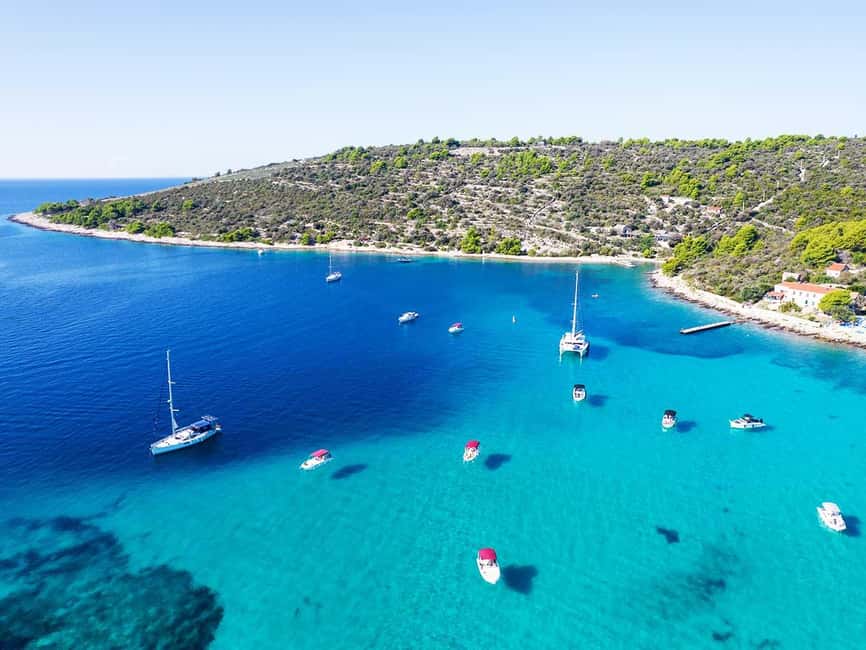 Trogir: Blue Lagoon, Maslinica, and Solinska Bay Boat Tour - Solinska Bay boat jump, pine-lined beach, and snorkeling time